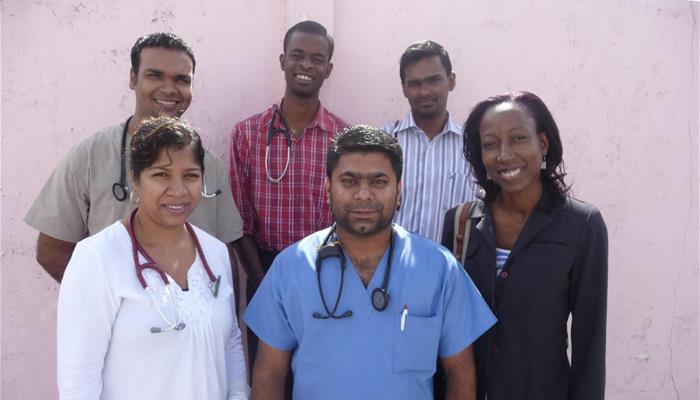 A group of six doctors smile in Guyana