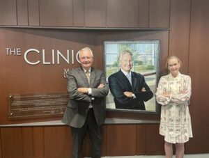 People posing in front of the clinic dedication area